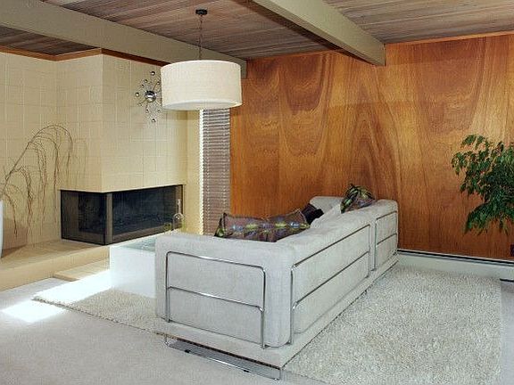 The Family Room has a fireplace and opens to a landscaped side patio.