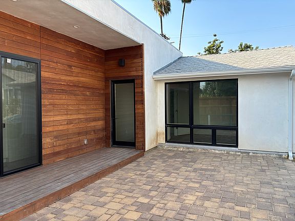 Front entrance, patio, and window to one bedroom