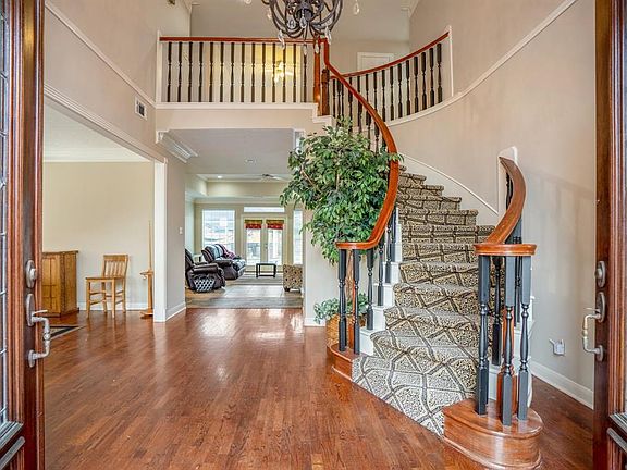 As you enter the home you are greeted by beautiful gleaming wood flooring and an impressive spiral staircase.