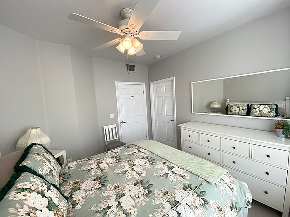 Queen size bed, dresser, ceiling fan, walk in closet