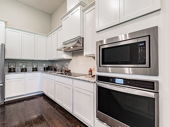 The chef-ready kitchen includes stainless-steel kitchen appliances.