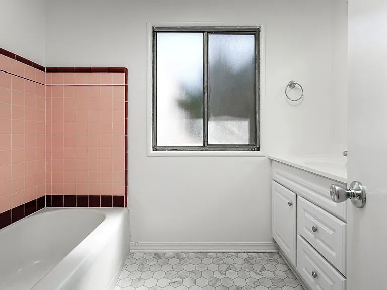 Upgraded bathroom with vanity and new floor covering