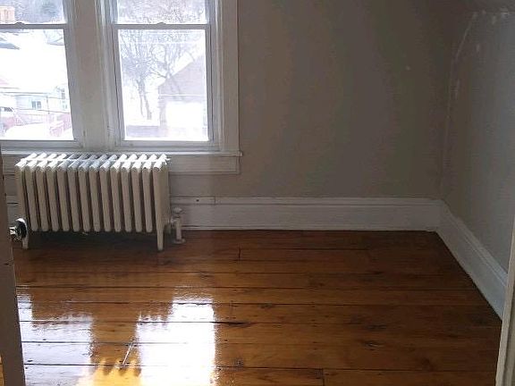 This West-facing 2nd bedroom offers a view of the neighborhood and sunsets over main street while being high enough to provide privacy