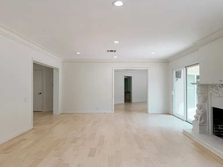 Elegant formal living room with crown molding and a classic fireplace showcases timeless charm in this Beverly Hills luxury rental home at 1094 Garden Lane, 90210.