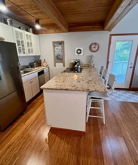 Side view of kitchen. Front entry door visible top right. Separate and private interior/exterior entrance.