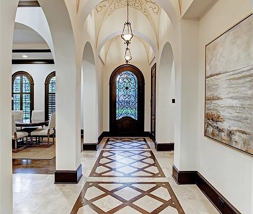 Classical groin vaults in foyer feature hand--work of Segreto Finishes. Inlaid oak and stone floor set off the custom arched 4'x9' Durango steel door.