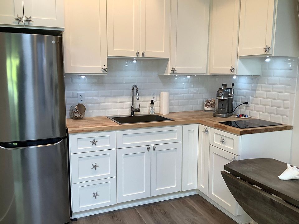 White tiled kitchen, LG new refrigerator, induction cooktop - 2 burners, no oven