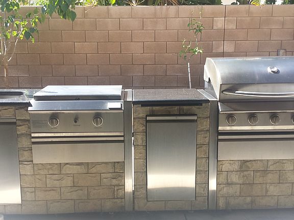 Built-in BBQ grill with burner, sink, and refrigerator
