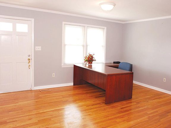 Receptionist/greeting area. Could be used as another office.