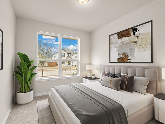 The secondary bedroom features plush carpet, fresh paint, closet, and a large window that lets in pl