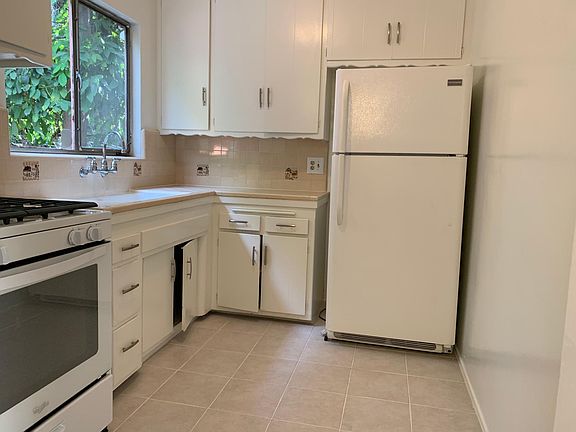 Newly tiled kitchen floor. New stove.