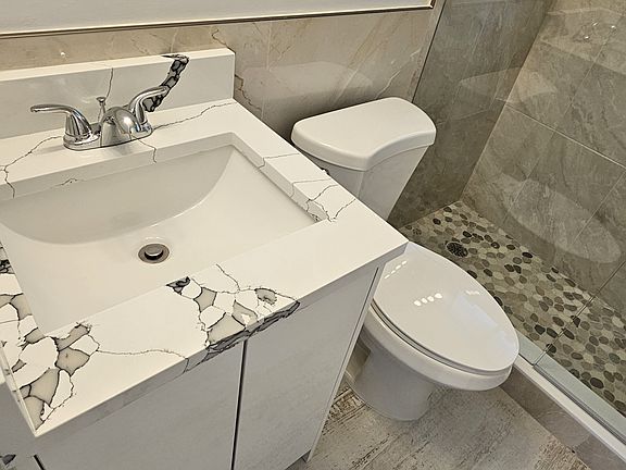 Beautifully patterned. sink tops match the kitchen counter tops. Elongated fast flushing toilets.
