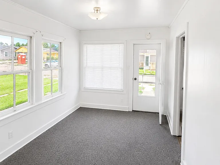 Sunny Dining Room / Bonus Room_perfect for family meals, a home office, playroom, or second living area.
