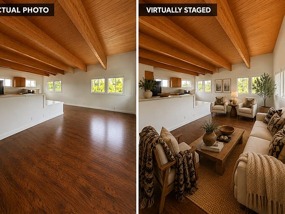 Unwind in a bright, open living space featuring gorgeous exposed wood beams, rich laminate floors, and a seamless flow into the kitchen.