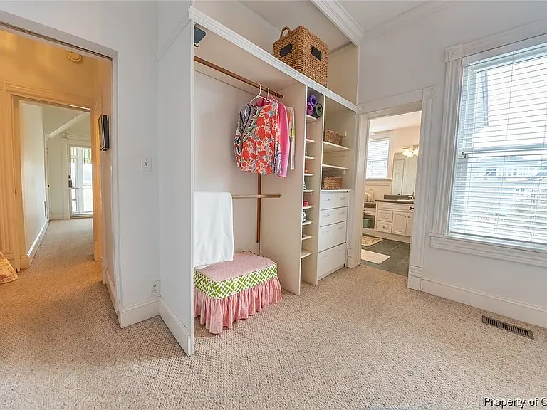 Changing area next to primary bedroom with closets and built in cabinets.