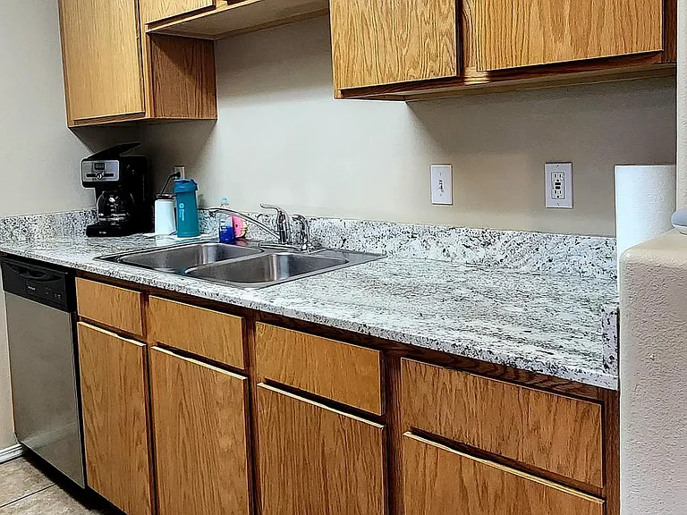 Kitchen with new dishwasher and garbage disposal. Upgraded granite countertops