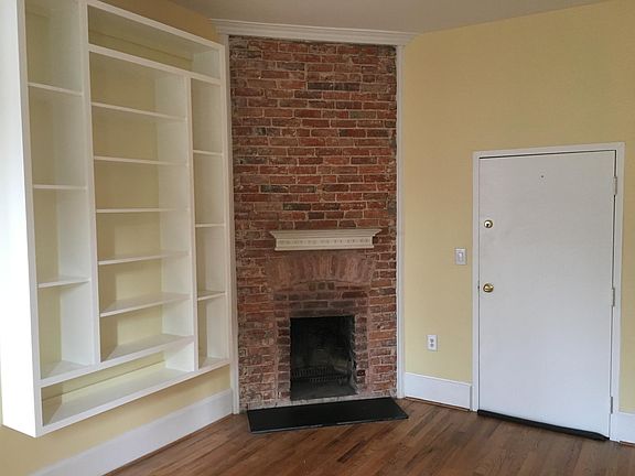 Living/dining w/ brick fireplace & built-ins