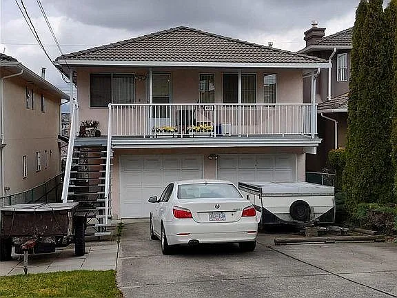 Back of the property. Left side of the garage.
