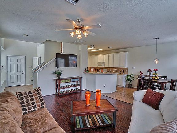 View of the living room looking towards the front door and the kitchen.