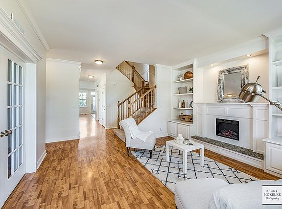 Another view of the Living Room ~ staircase and hallway leading to formal Dining Room and Kitchen