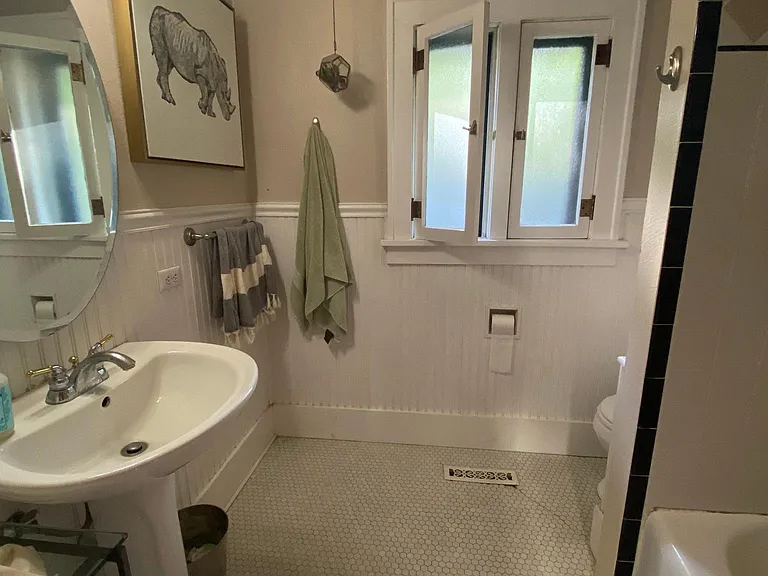 April 2025-Bathroom: funtional windows with screens, original penny tile flooring