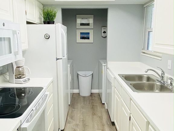 Kitchen with dishwasher, washer, dryer, new oven, range and microwave and refridgerator