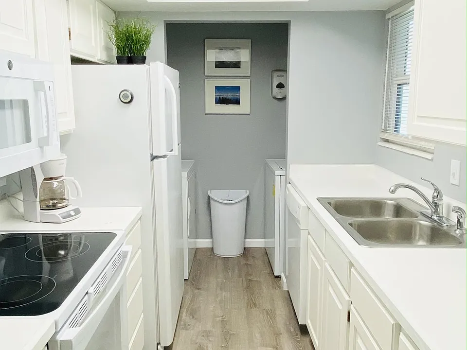 Kitchen with dishwasher, washer, dryer, new oven, range and microwave and refridgerator