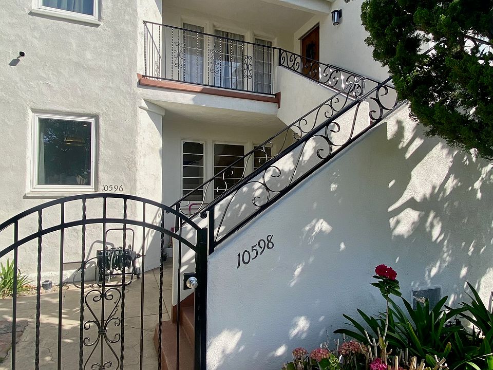 close up of gate and bottom of stairs going up to the unit