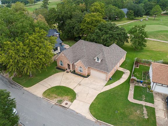 Looking down on the Circular Drive, entry to attached garage and the side entrance to the golf cart garage.