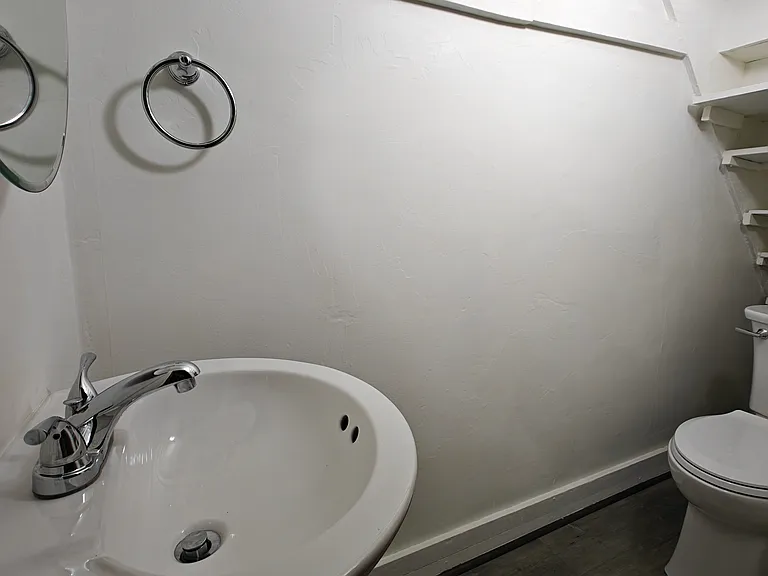 Updated half bath with new toilet and added sink and mirror. Motion sensor light installed for lighting in this bathroom.