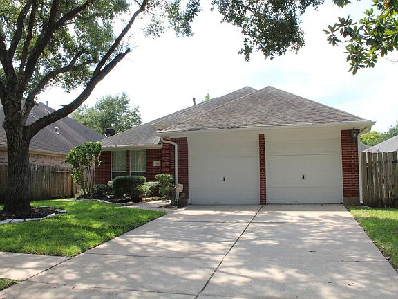 Beautiful red brick exterior and lush landscaping for great curb appeal