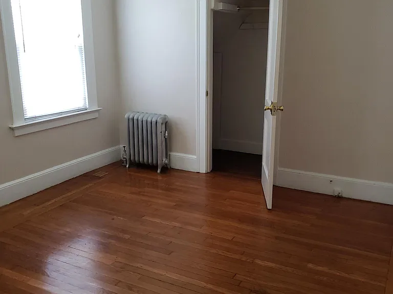 View of larger bedroom with walk-in closet