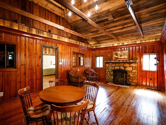 Original cabin living room. Original hardwood floors and panelling.