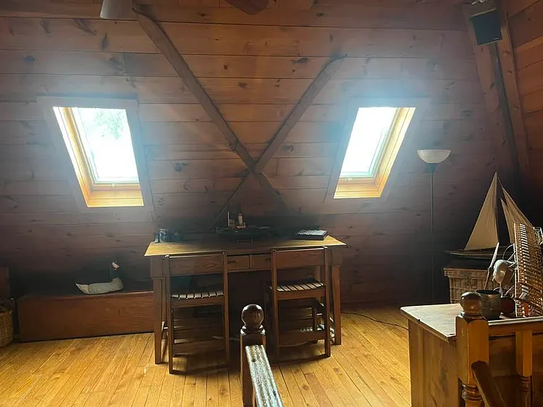 West view of great room - tall Cherry Desk, blanket chest for storage.