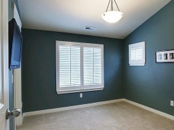 Private corner room with vaulted ceiling, walk in closet, carpeted. Comes furnished with bed, desk and chair.