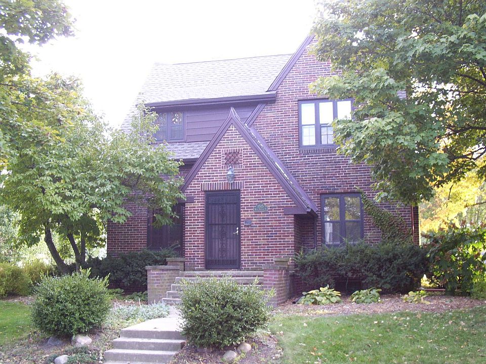 This custom 1929 craftsman Tudor home has unique, variegated brickwork.