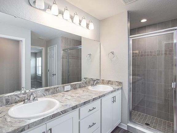 En-suite owner s bath with dual vanities - New home for sale in Lake Alfred, FL - Photo showcas