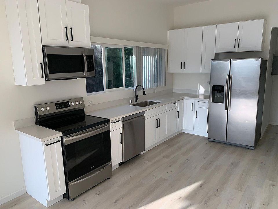 Open Concept Kitchen with Microwave, Stove, Dishwasher and Fridge.
