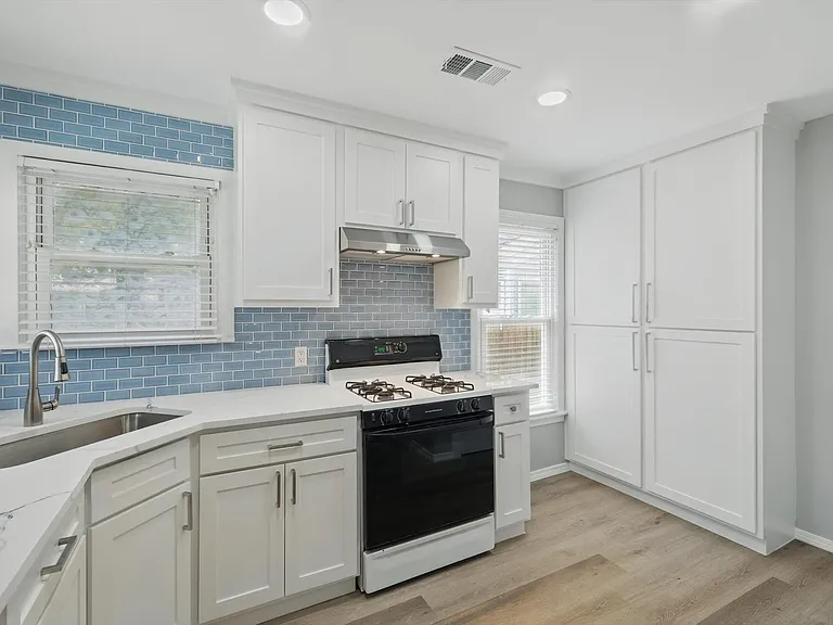 Recently updated kitchen featuring quartz countertops, white cabinets, new spacious pantry and dedicated utility closet. Washer and dryer included.