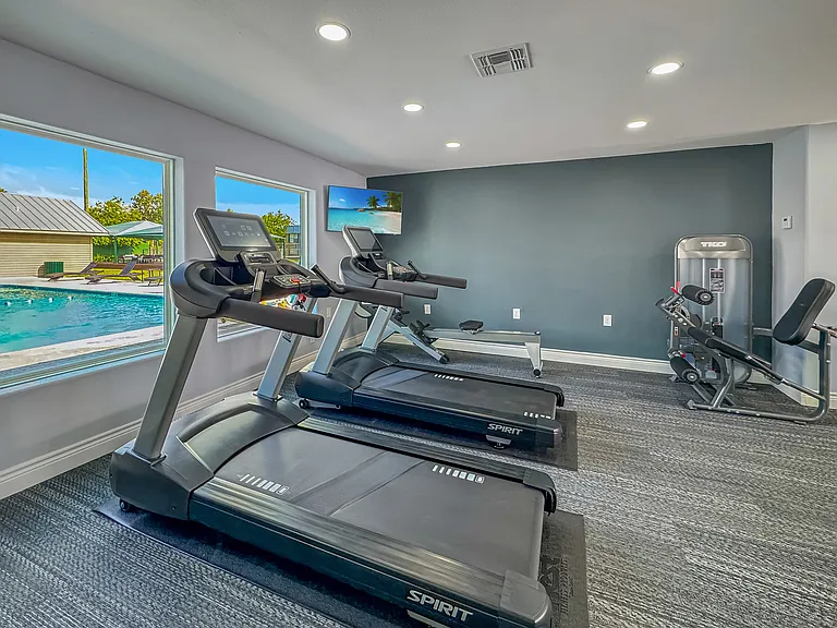Cardio workouts with poolside views at Borders Apartments in Brownsville TX.
