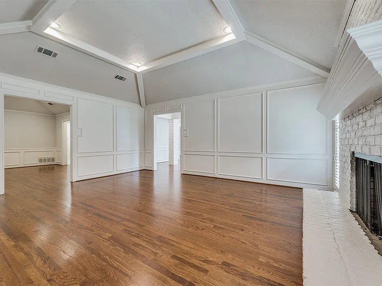 Living room, with den at left rear
