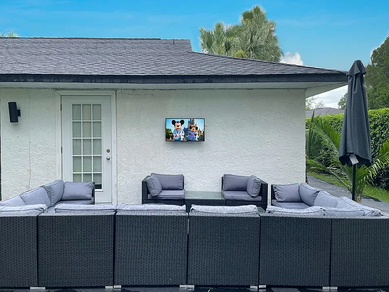 Back garden with outdoor living room style patio area overlooking lake and Saddlebrook Golf Resort Course.