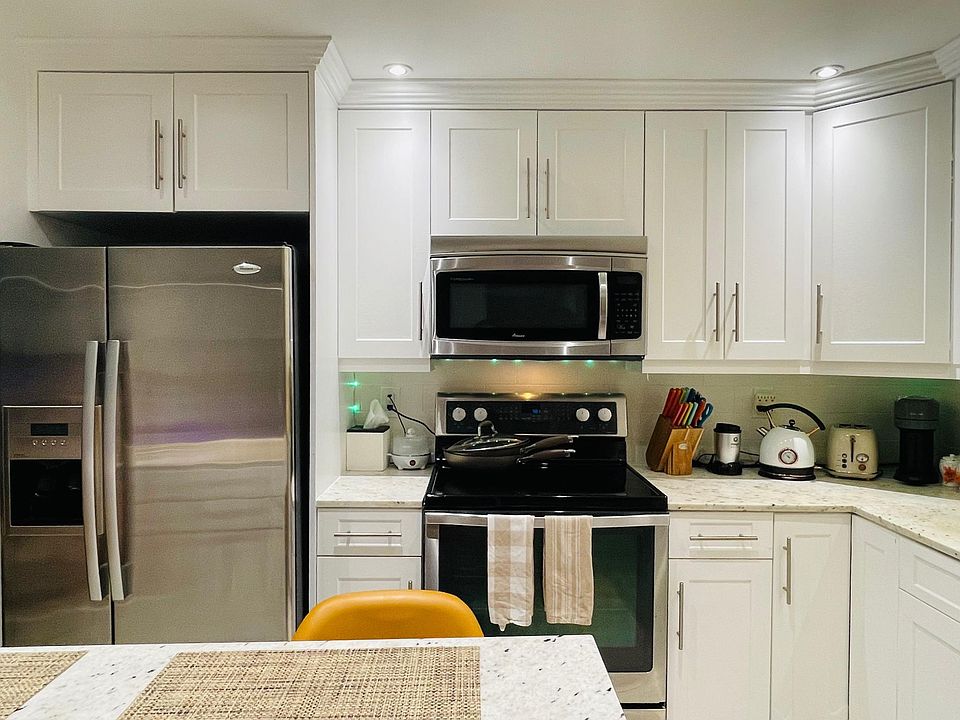 Kitchen appliances including fridge, microwave, oven and dishwasher