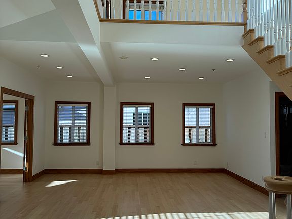Formal living room with view of upstairs loft area