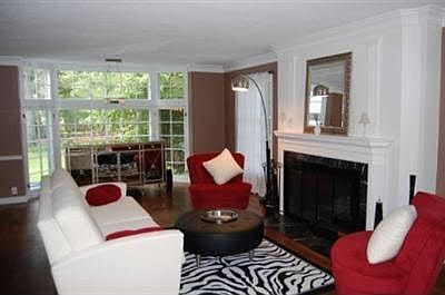 Living room with floor-to-ceiling windows and woodburning fireplace