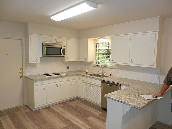 kitchen with granite counters , undermount stainless sink, microwave and dishwasher