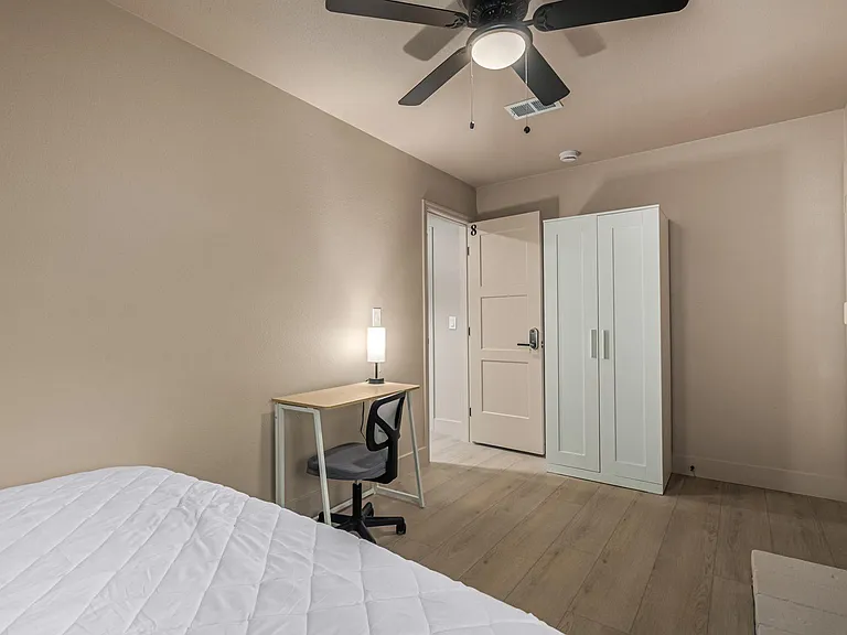 Actual bedroom: queen bed, desk, chair, lamp, fan, closet. PRIVATE ENTRANCE
