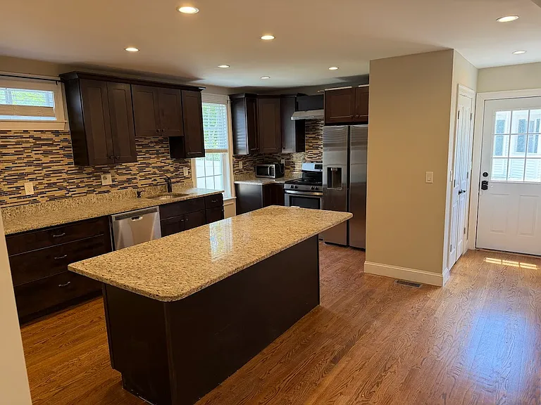 Open Kitchen Concept with Island and Stainless Steel Appliances