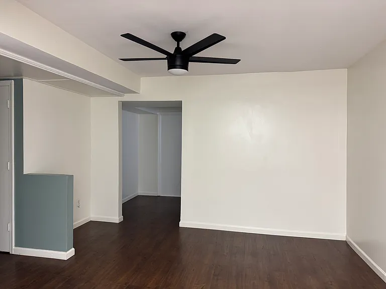 Living room w/ desk nook and laundry.
