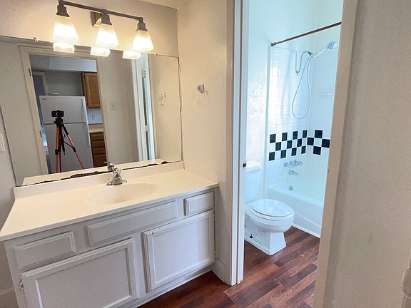 Vanity area featuring sink, storage below, and access to the bathroom.